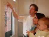 Home energy auditor points out the air leaks around a door