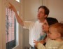 Home energy auditor points out the air leaks around a door
