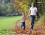 Mother and son running outside