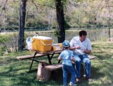 Meri's dad helps get her fishing pole ready