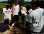 The kids learning how to plant trees.