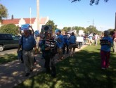 Protesters line sidewalk after being turned away from State Department meeting parking lot by Americans for Prosperity.
