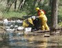 Disaster response workers clean debris and oil from the Yellowstone River after an Exxon pipeline ruptured, dumping 42,000 gallons of petroleum. (Photo: US Coast Guard)