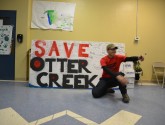 Kaden Walksnice getting signatures on the Save Otter Creek sign