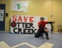 Kaden Walksnice getting signatures on the Save Otter Creek sign