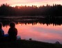 Kids watching sunset at a lake