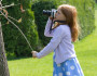 A young photographer takes pictures of an insect in a tree. Photo by National Wildlife Photo Contest entrant Anne Girton.