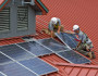Workers installing rooftop solar panels. US National Forest Service photo by Alex Snyder.