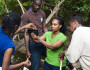 Na'Taki conducting stream monitoring with Earth Tomorrow students.