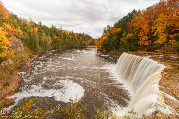 The brilliant shades of autumn frame Tahquamenon Falls in Michigan. Photo by National Wildlife Photo Contest entrant Marilyn Cassell.