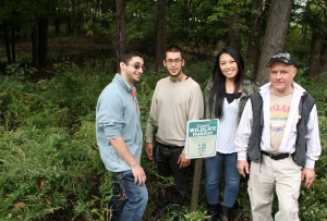 Zachary Stuhmer, RCC Alumni, Angel M. Jimenez-Mora, Masako Hiraoka, and Biology Lab Assistant Kevin Rapelye in front of the Wildlife Habitat Trail.