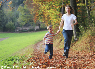Mother and son running outside