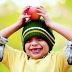 Little boy holding an apple