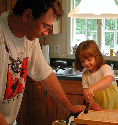 David and his daughter Audrey check the honey comb