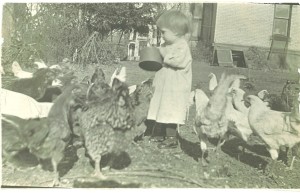 Florence Schilbe, John's mother, feeds chickens in her Michigan backyard at the age of 2  in summer 1914. She learned early to value animals.