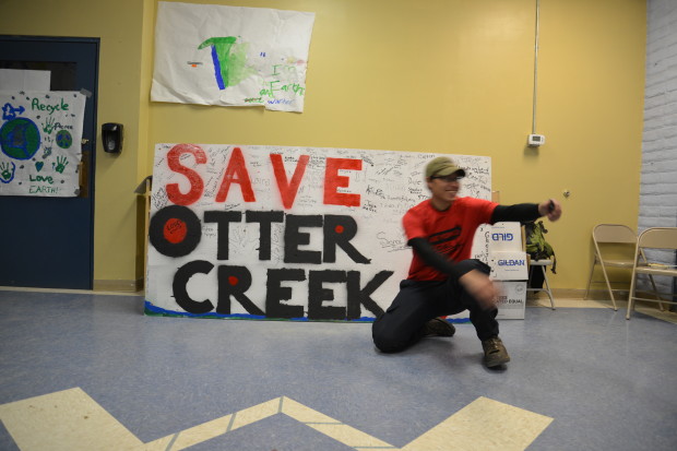 Kaden Walksnice mans the Save Otter Creek sign at the Inter-Tribal No Coal Gathering in Lame Deer. Photo copyright Alexis Bonogofsky