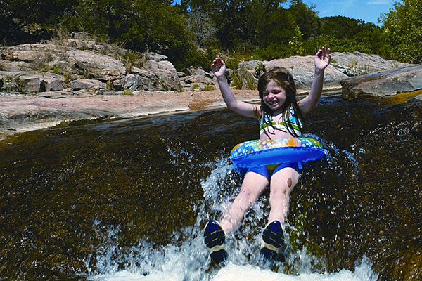 Girl tubing on Blanco River. Photo: Texas Parks and Wildlife Department