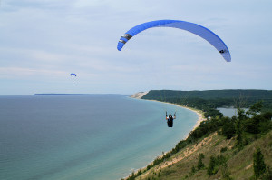 The 1.3 million visitors to Sleeping Bear Dunes National Lakeshore in Michigan, like these hang gliders, generated $136 million in spending in 2013, according to Headwaters Economics. Source: flickr, sleepingbeardunesnps