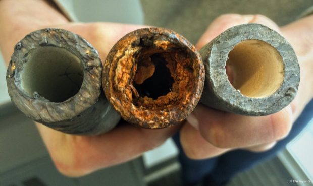 This image shows a corroded lead pipe (center). The people of Flint were being told that water so corrosive it prompted General Motors to stop using it on automobile parts at their engine plant, was safe to drink. Photo: US EPA Region 5