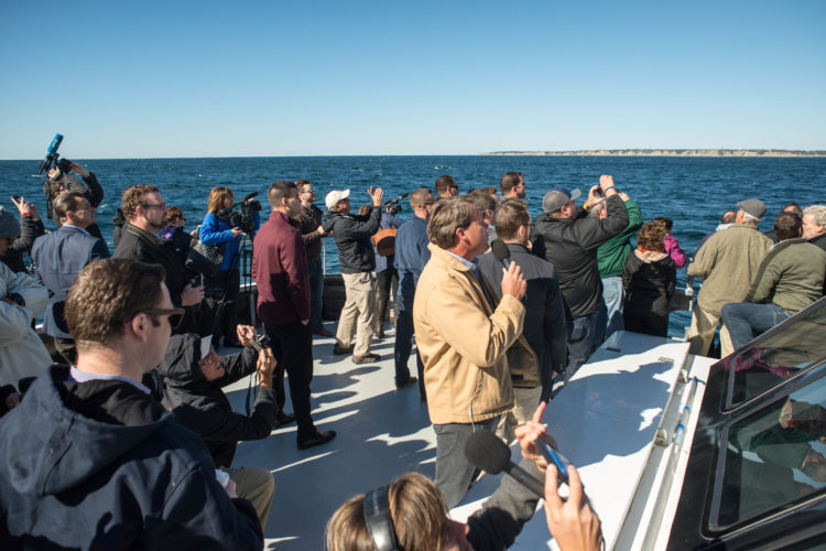 A crowd of onlookers at America's first offshore wind turbines.