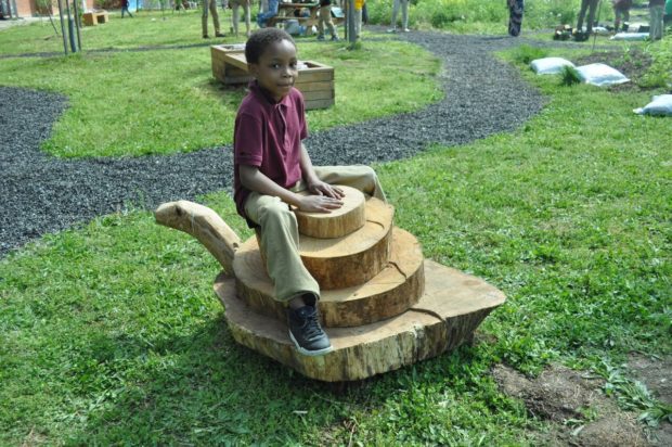 child on wooden sculpture
