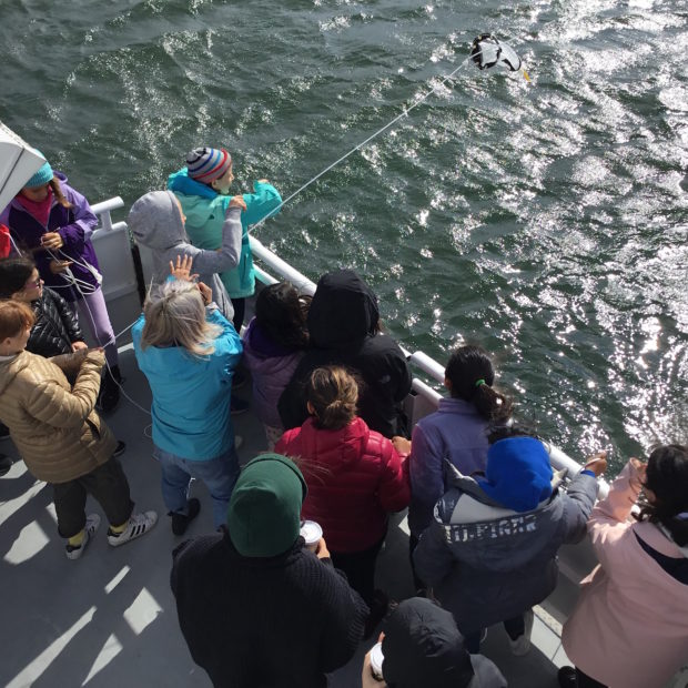 Climate education students launch a plankton tow. 