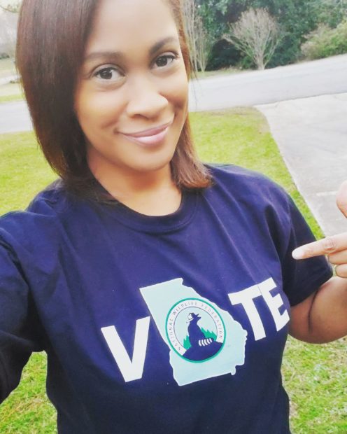 woman pointing to "vote" t-shirt