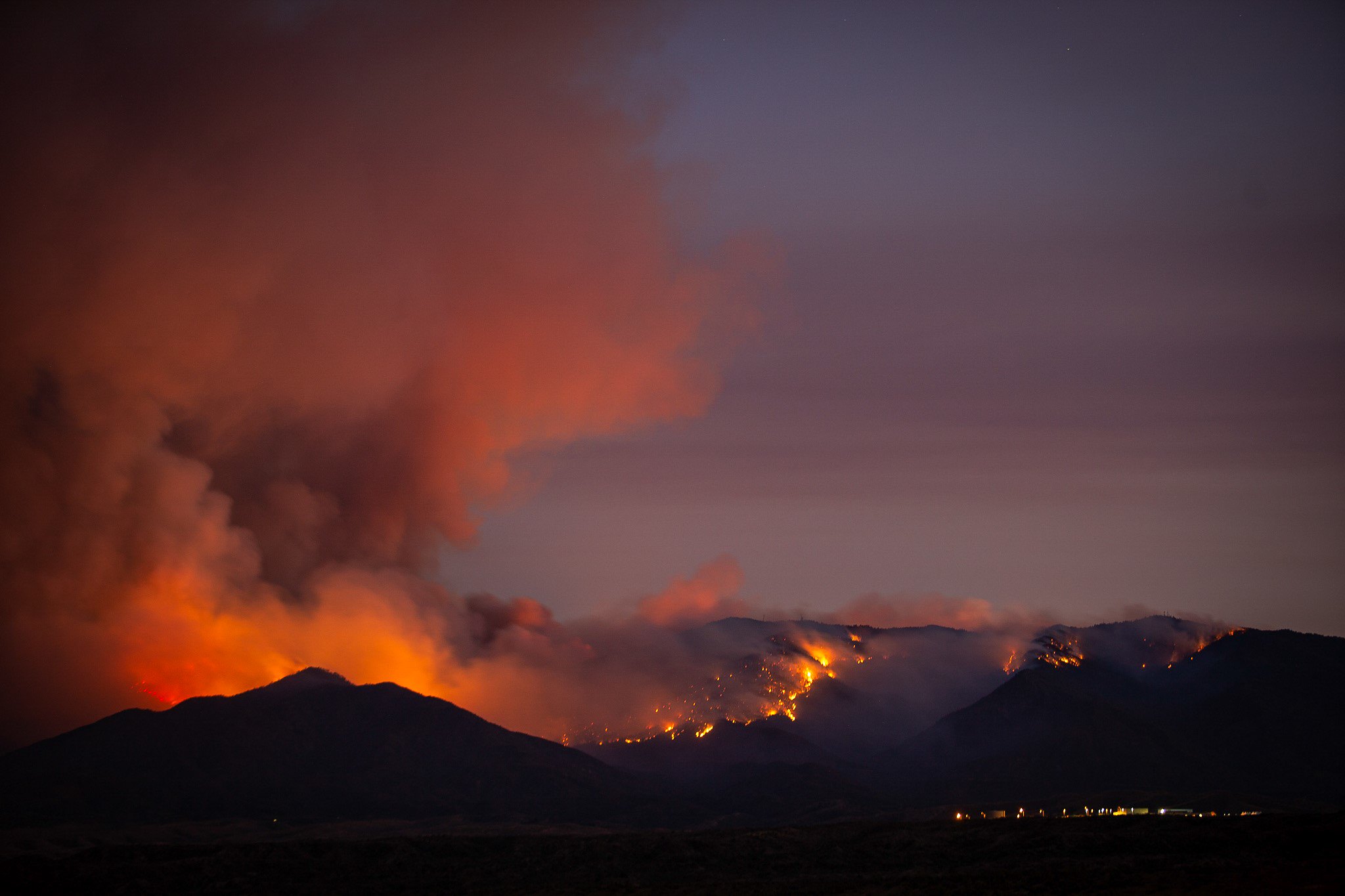 fire on mountain tops at nighttime