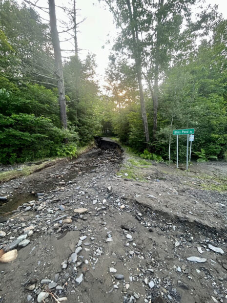 Gravel road damaged by floodwaters.