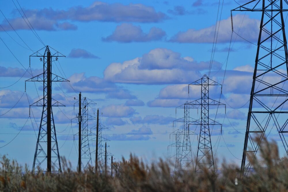 Transmission lines against a blue sky background.
