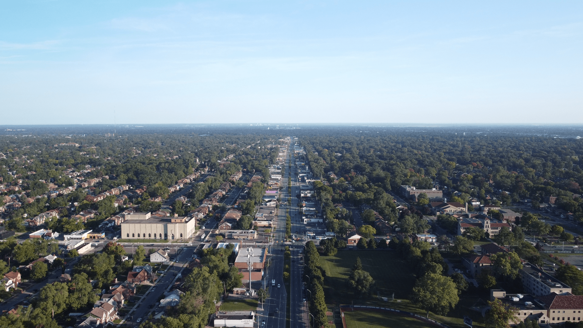 Aerial view of a main street through a community.