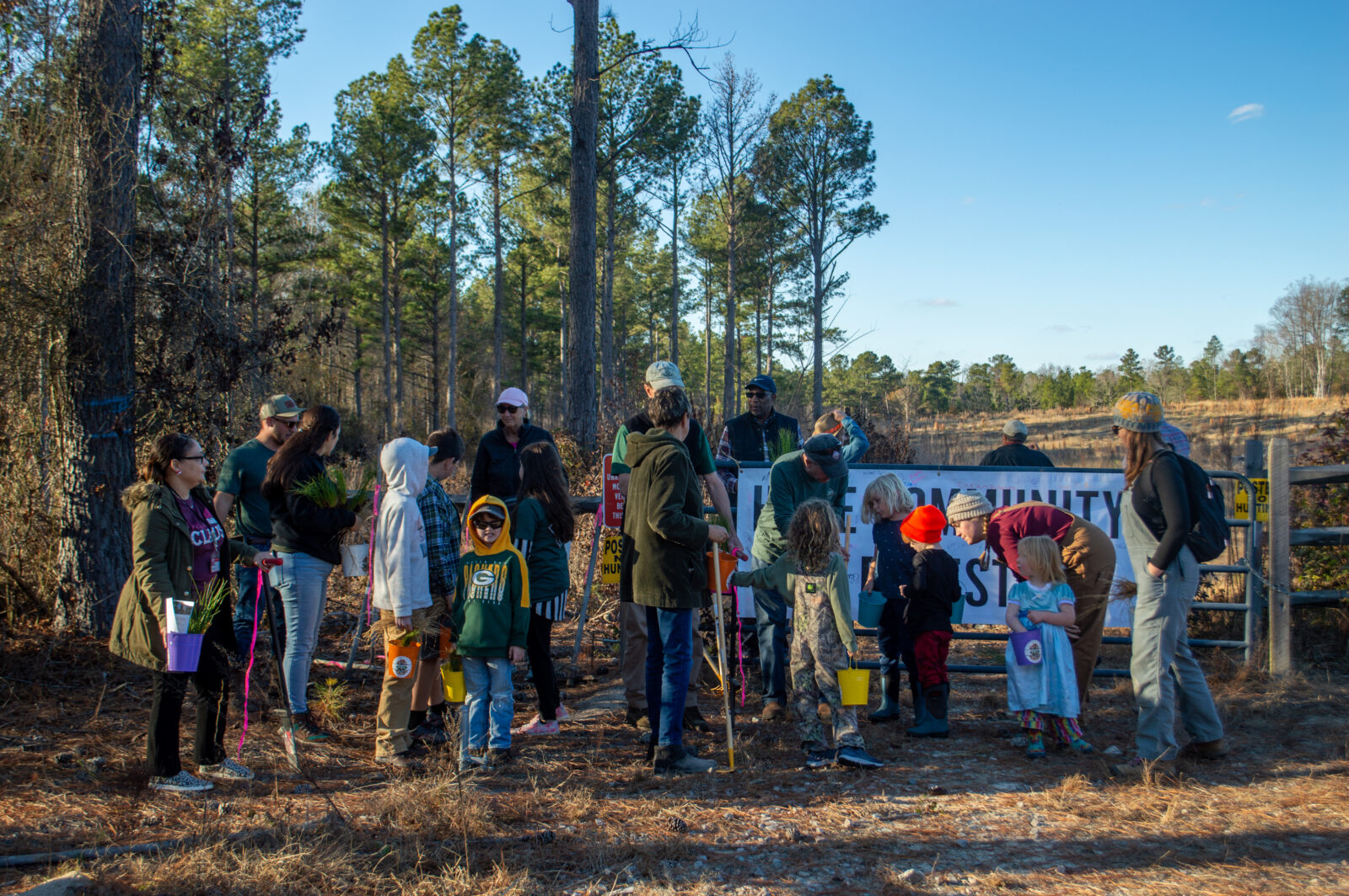 A group of people stand outside.