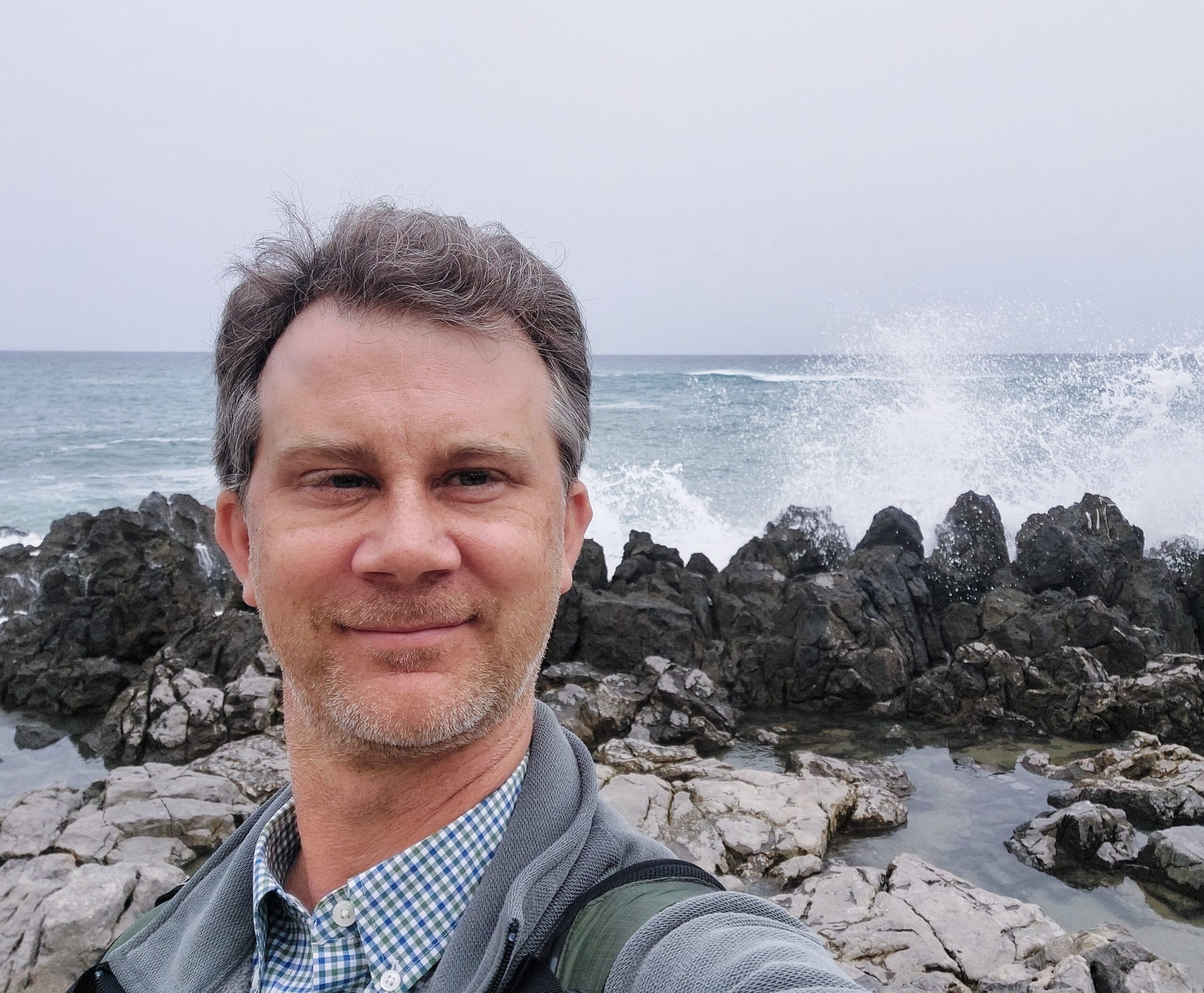 A selfie in front of crashing waves.