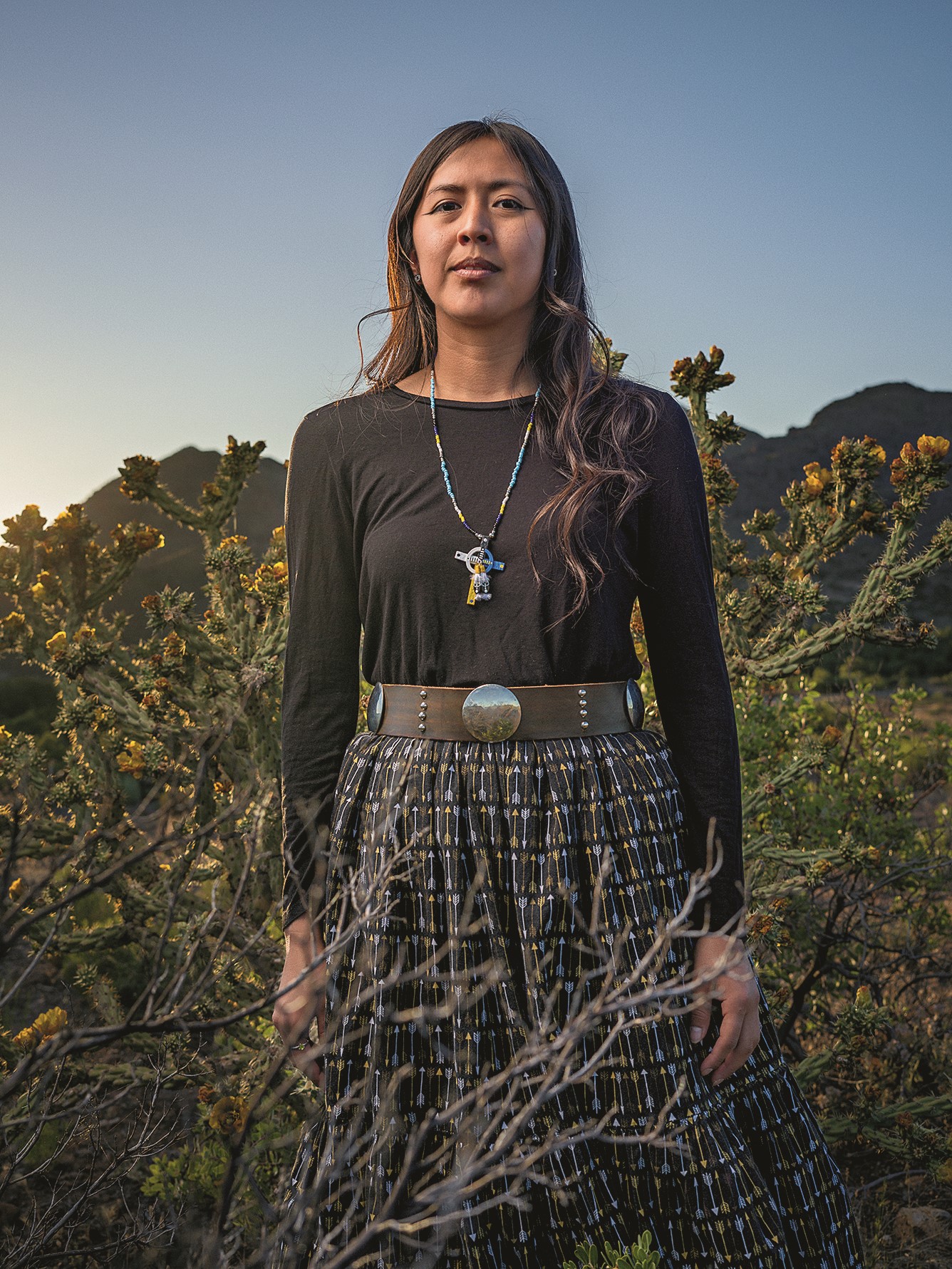 A person poses outside for a photo.