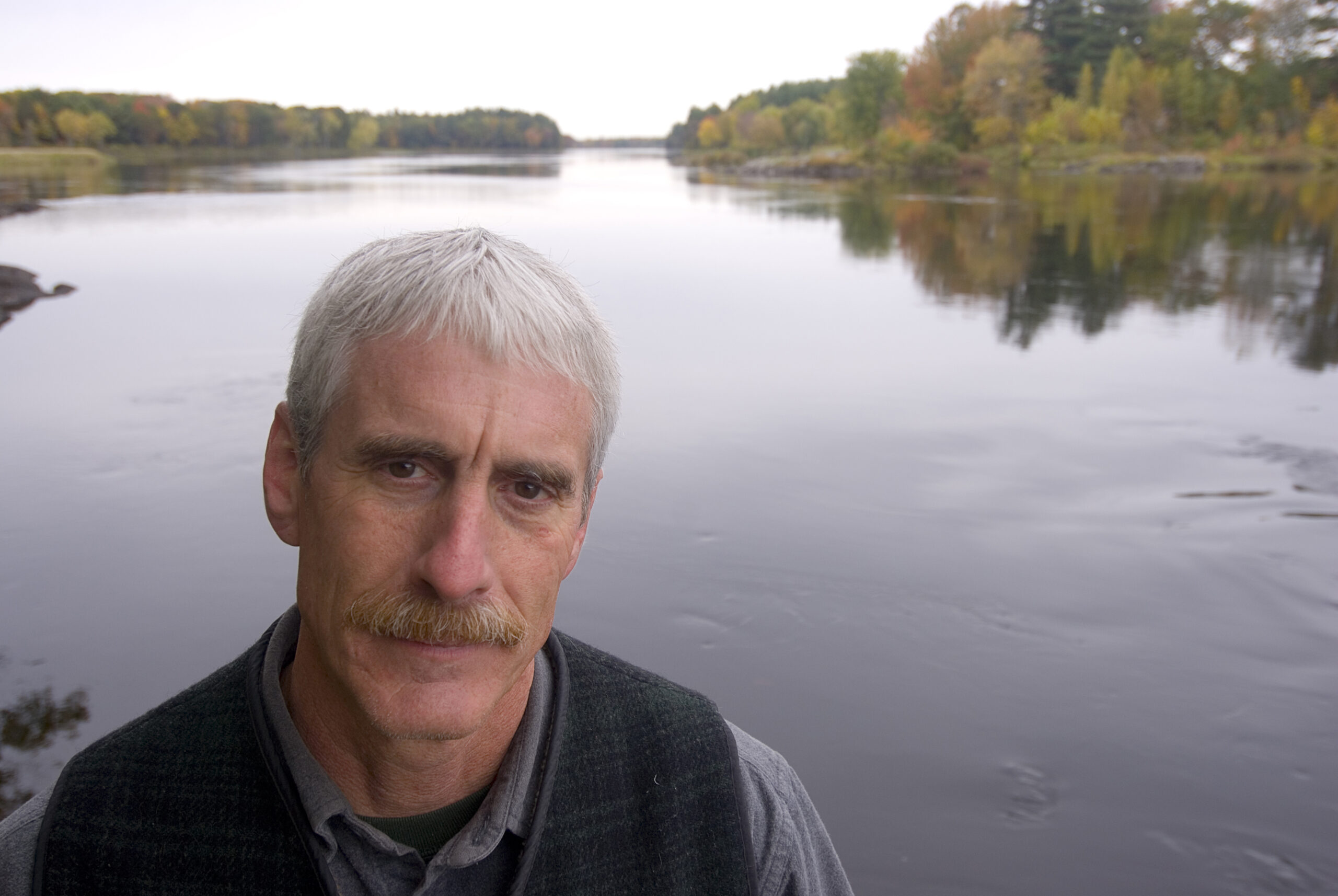 A selfie of a person in front of a body of water.