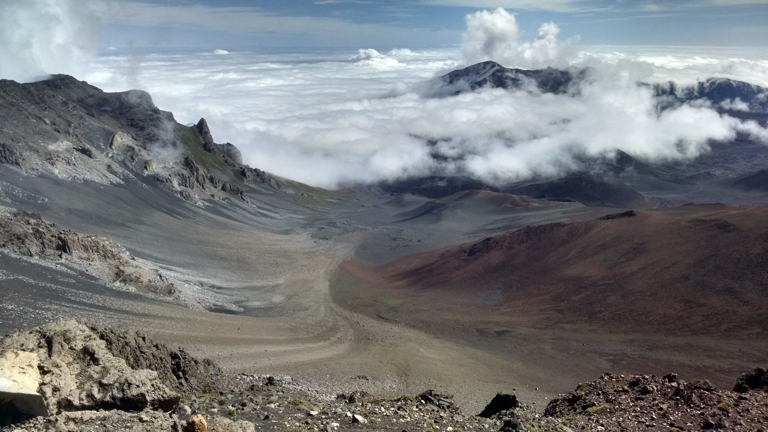 Wide view of a cloudy mountain peak.