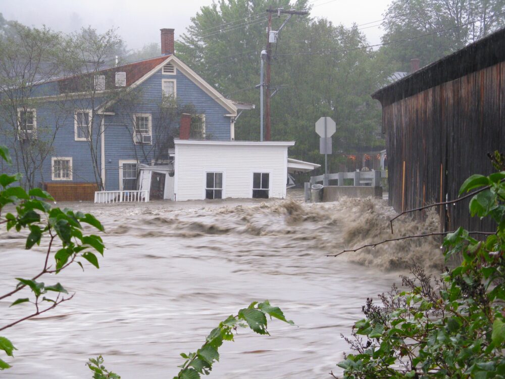 Flooding from a storm. A house can be seen standing in water up to its windows.