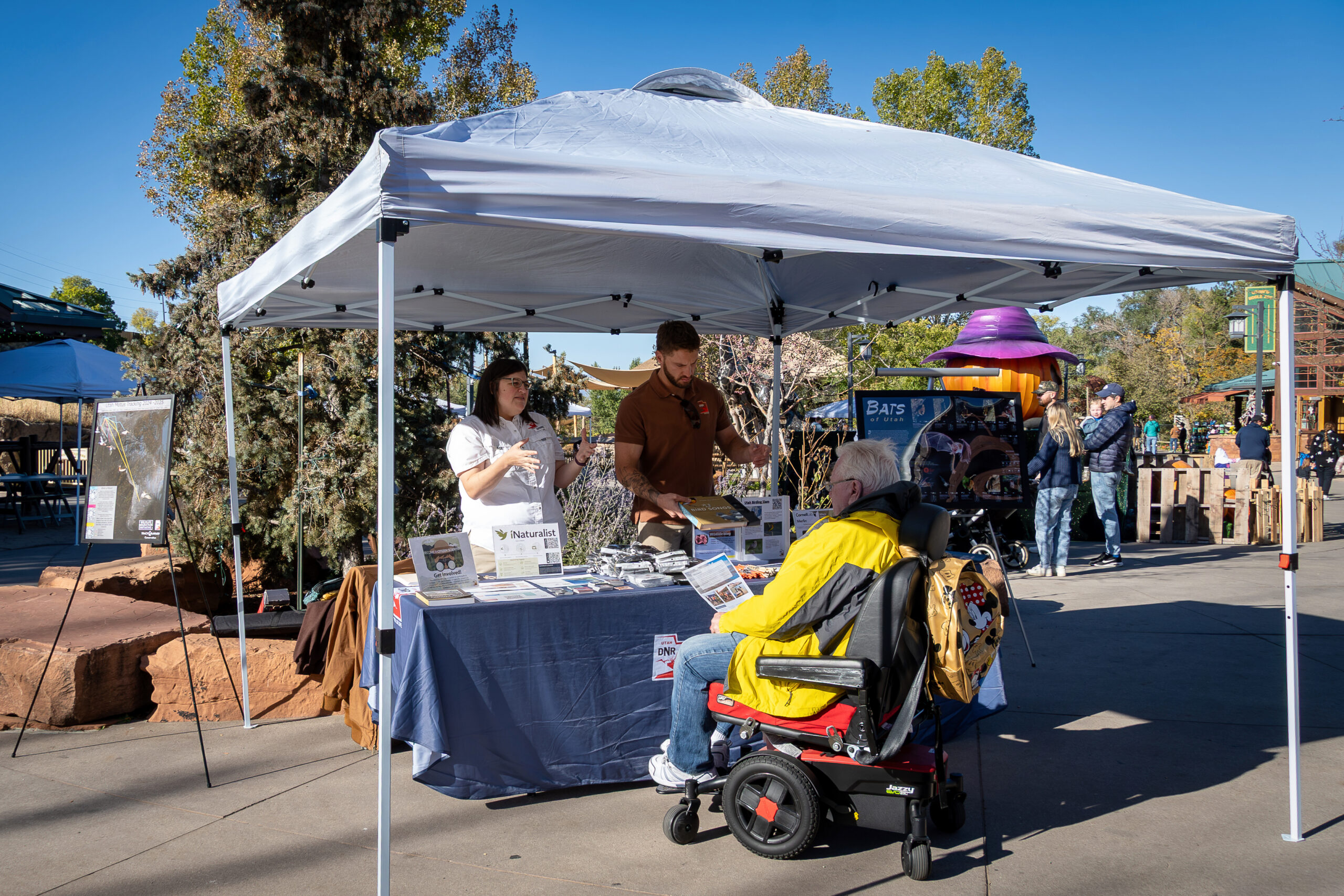 People attend an outdoor tabling event.